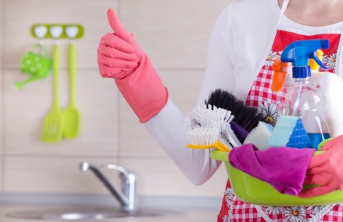 Domestic cleaner working in a modern Ilford apartment kitchen
