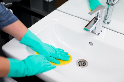 Professional Cleaner Ilford staff following safe cleaning practices